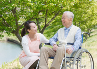 caregiver and senior man smiling each other