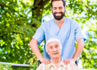 caregiver massaging old woman